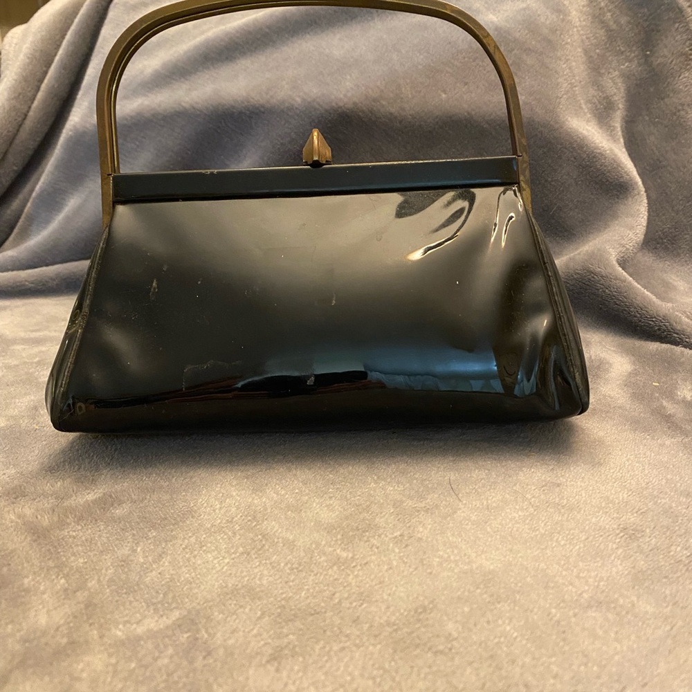 Elegant Black and Gold Clutch with Structured Shape and Curved Handle